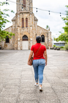 Unknown woman walking along a boulevard