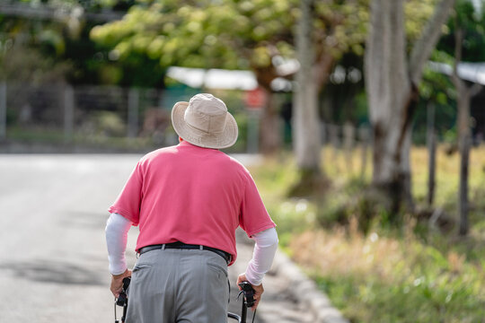 Rear of an old man walking with his walker