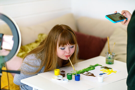woman with down syndrome drawing