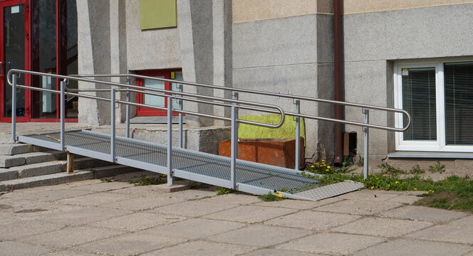 A  metal ramp and stairs for wheelchairs  in a  school for disabled  children