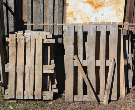 Old used wooden pallets near a rustic barn