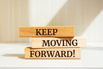 Wooden blocks with words 'Keep Moving Forward'.