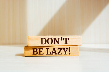 Wooden blocks with words 'Don't Be Lazy!'.