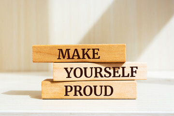 Wooden blocks with words 'Make Yourself Proud '.