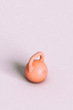 a pink kettlebell on a violet background with copy space