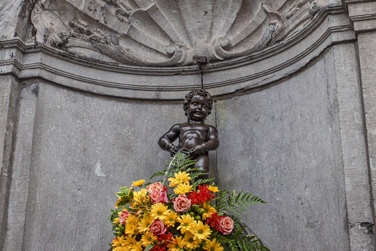 BRUSSELS, BELGIUM - June 5, 2022: Manneken Pis statue in Brussels. Statue of a pissing boy in a beautiful summer day in Brussels, Belgium on June 5, 2022
