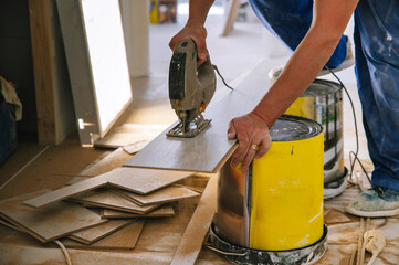 Crop handyman cutting floor plank