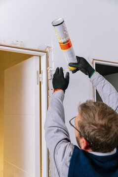 Man using expanding foam on doorway