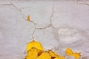 white and yellow cracked old wall