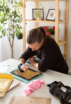 Artist works on digital design on a tablet