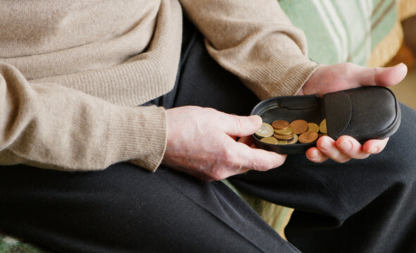 Senior man looking for money in his wallet