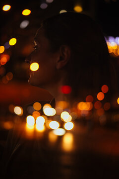 night portrait of a woman merged with city lights