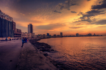 Sunset at Malecon, the famous Havana promenades where Habaneros, lovers and most of all individual fishermen meet, Havana, Cuba - obrazy, fototapety, plakaty