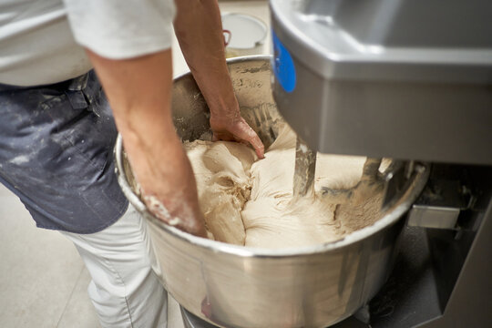 Crop baker mixing dough in machine