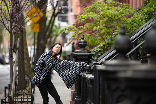 Woman on sidewalk smiling