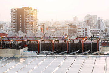 rooftop of building HVAC Air Chillers with solar panel. modern Bangkok city landscape.