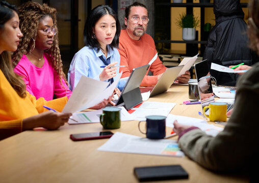 Diverse business people working overtime