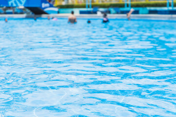Fototapeta na wymiar swimming pool blue water people leisure playing in summer season