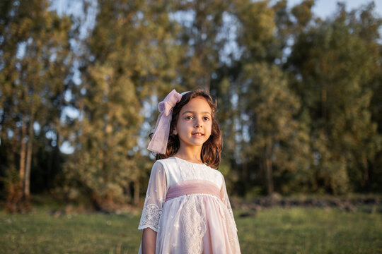 little girl in the field with a nice dress
