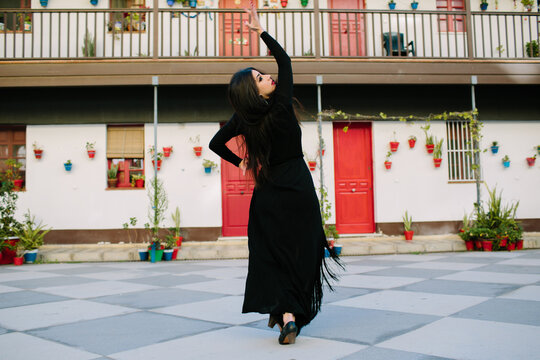 Woman dancing flamenco in a beautiful colorful street