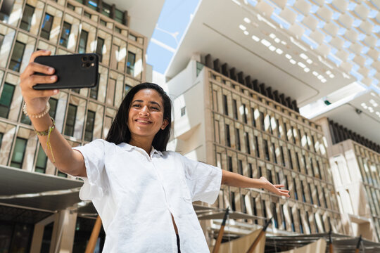 Young arabic woman using cellphone.