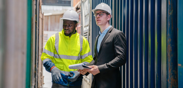 Manager and contenner worker working in the construction container yard