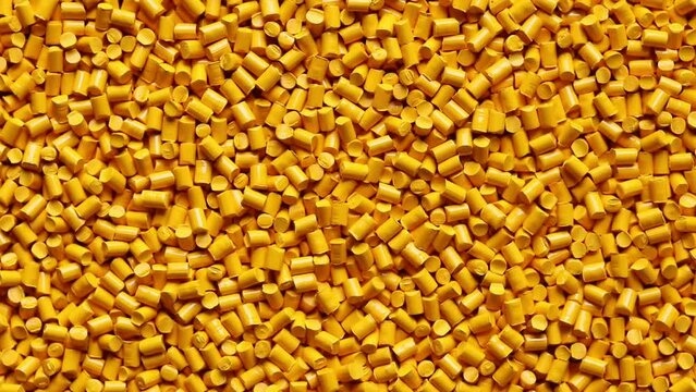 top view of orange plastic resin ( Masterbatch ) rotation background