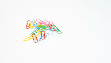 stationery colored paper clips on a white background with a place for text
