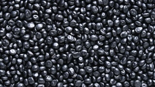 top view of black plastic resin ( Masterbatch ) rotation background
