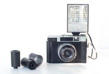 antique film camera with flash, film reel, on white background