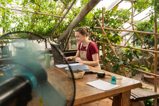 Woman Working In Greenhouse Arbour
