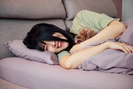 Young woman sleeping with her dog