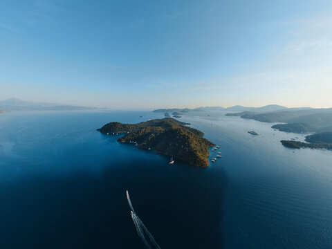 inhabitant green Island near Gocek with yachts passing by
