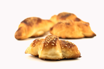 Homemade rolls with sesame stuffed with cheese isolated on a bright background. Selective focus. Close up.