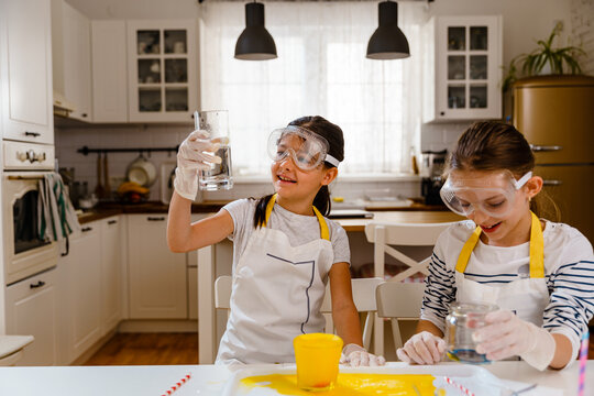 Children doing homemade experiments with kitchen food supplies 