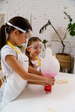 Children doing experiments with home food supplies and having fun 