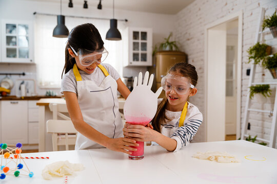 Children doing experiments and having fun in the kitchen 
