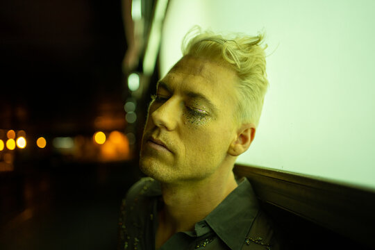 Portrait Of A Lonely And Depressed Man With Closed Eyes At Night.