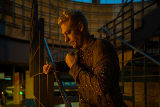 Lonely And Worried Man With Depression Outdoors At Night.