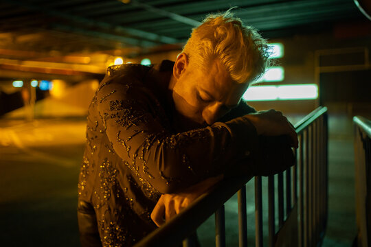 Lonely And Worried Man With Depression Outdoors At Night.