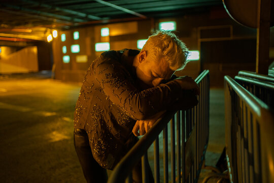 Lonely Man With Depression In A Dark Place At Night.