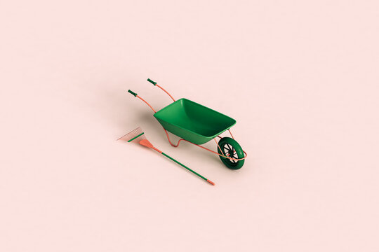 a green rake and wheelbarrow