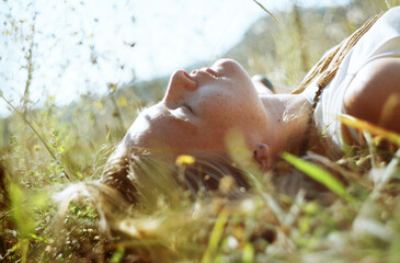 Blond woman lying in the grass