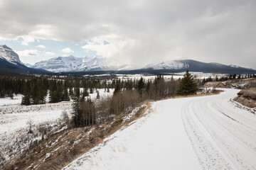 A Snowy Road Leading To The Mountains