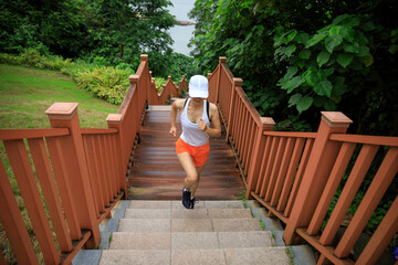 Fitness woman runner running on seaside boardwalk