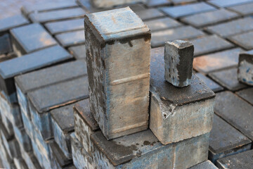 Gray paving slabs at a construction site. Material for paving roads and sidewalks. Close-up. Concrete tiles.