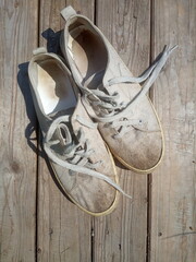 old worn out and dirty white sneakers
