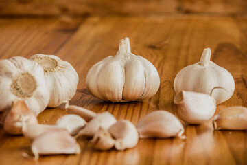 Garlic is a culinary and medicinal plant on a wooden background