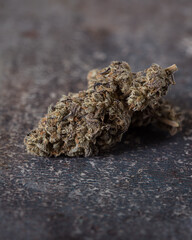 Cannabis buds trimmed and dried against a neutral light background