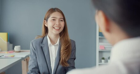 Young Asia businesswomen applicant pass job interview for enterprise company position or during corporate business meeting sitting on office desk at workplace. Hire candidate at job interview concept.